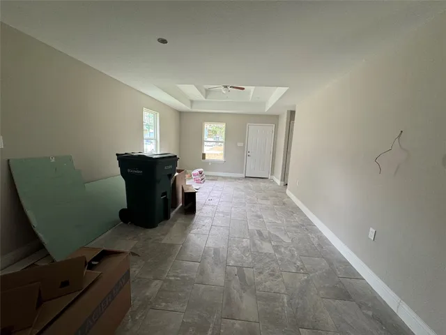a view of a room with furniture and a window