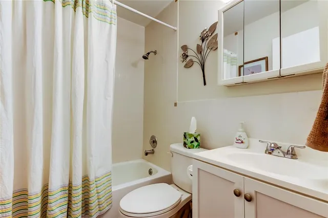a bathroom with a sink a toilet and shower curtain