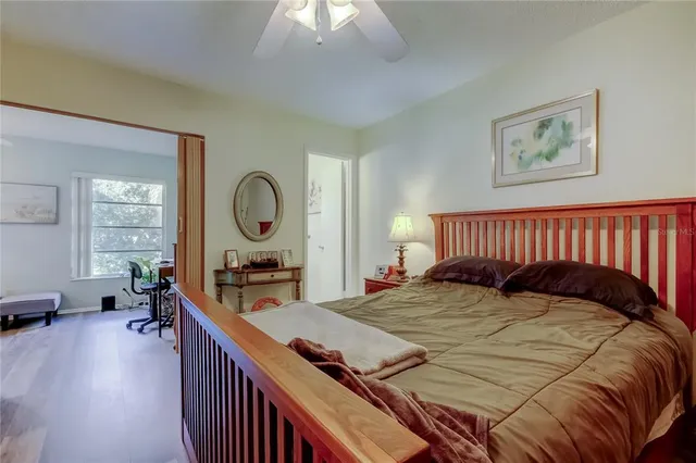 a bed sitting in a bedroom next to a window