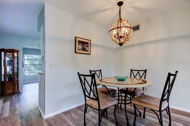a view of a dining room with furniture wooden floor and a chandelier