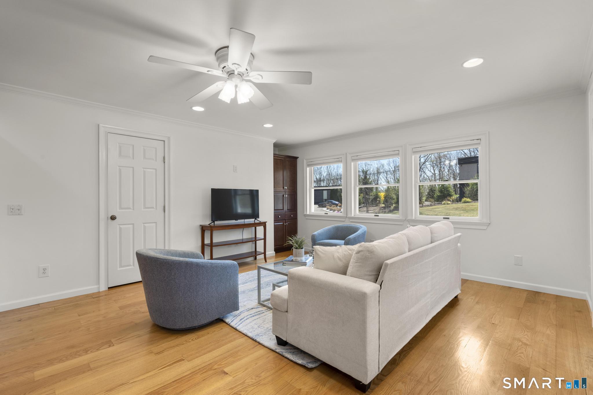 18 Edith Lane Wilton, CT 06897 - Photo 12 of 35 a living room with furniture and a flat screen tv