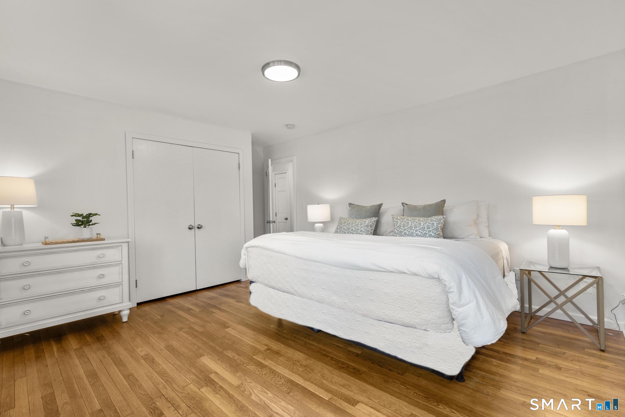 18 Edith Lane Wilton, CT 06897 - Photo 17 of 35 a bedroom with a bed and a mirror
