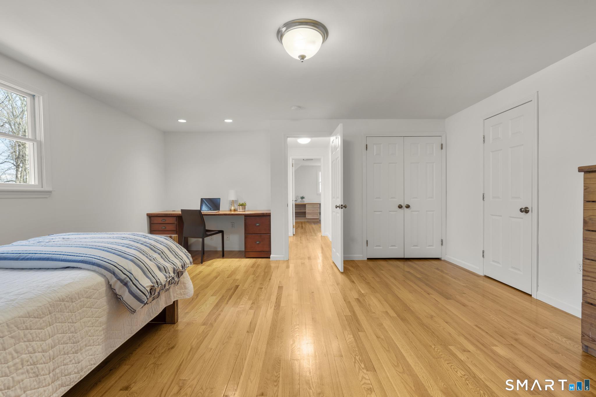 18 Edith Lane Wilton, CT 06897 - Photo 23 of 35 a spacious bedroom with a bed and a table