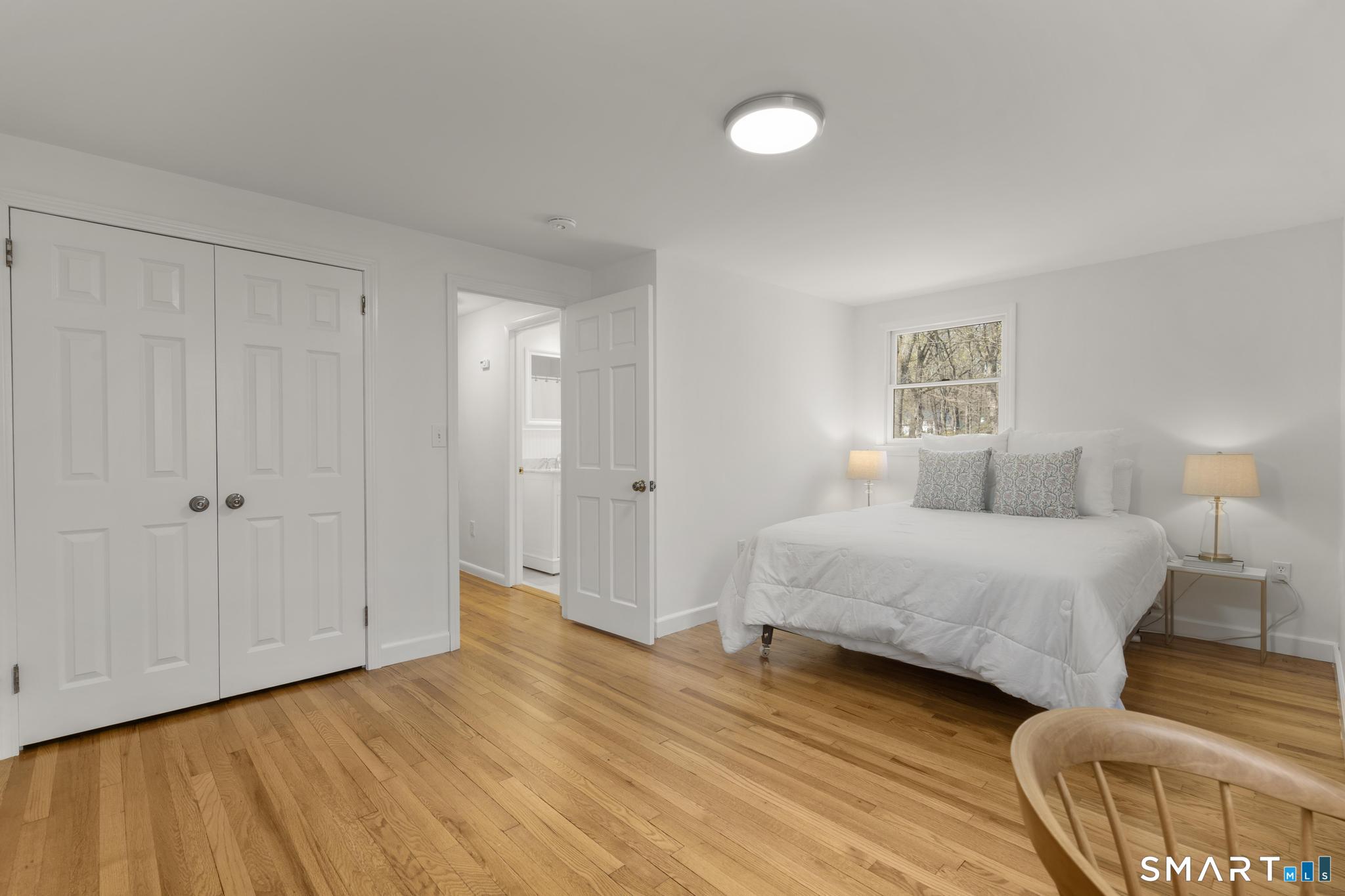 18 Edith Lane Wilton, CT 06897 - Photo 25 of 35 a spacious bedroom with a bed and a night stand