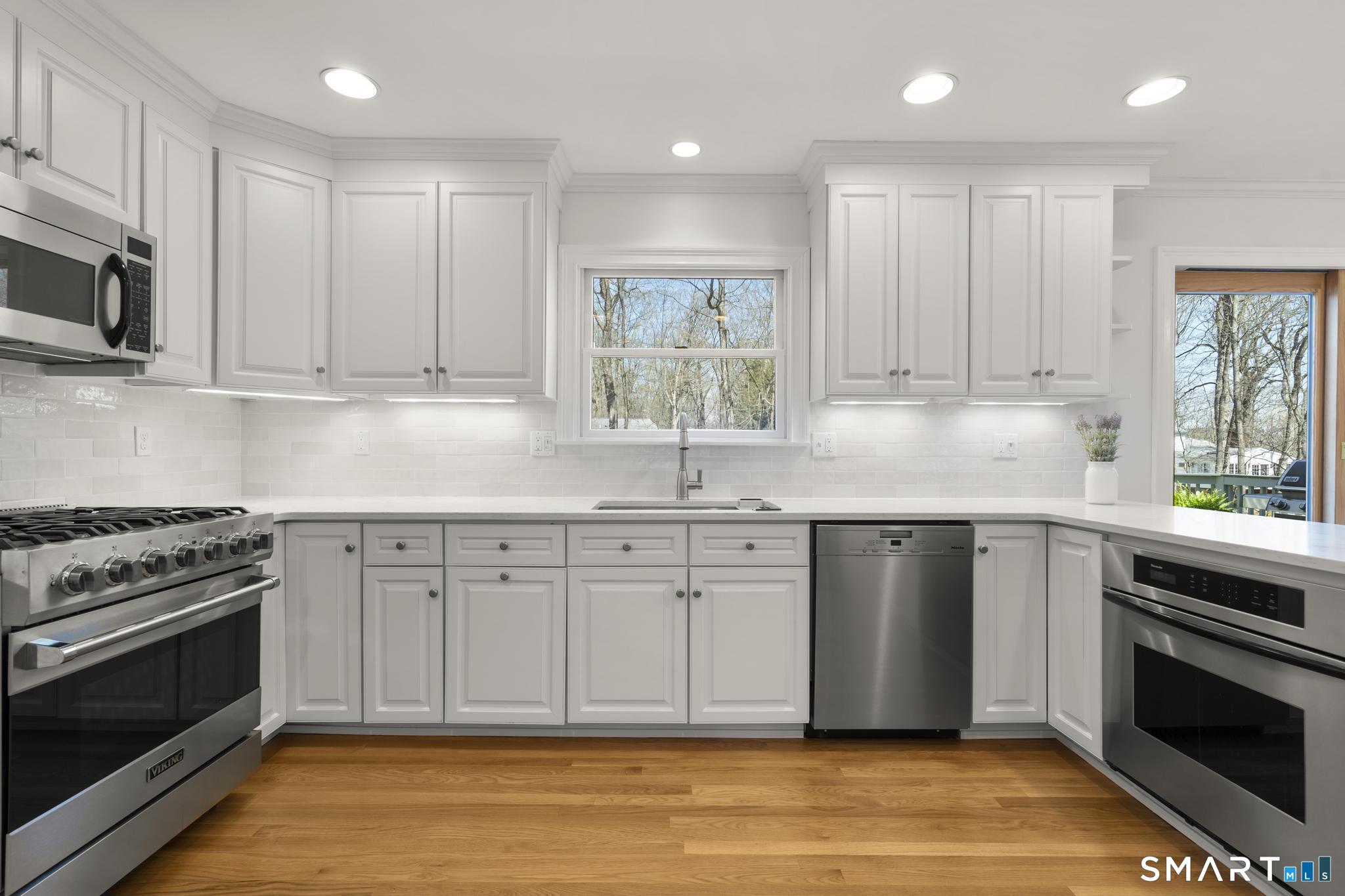 18 Edith Lane Wilton, CT 06897 - Photo 9 of 35 a kitchen with stainless steel appliances granite countertop a stove a sink and a microwave