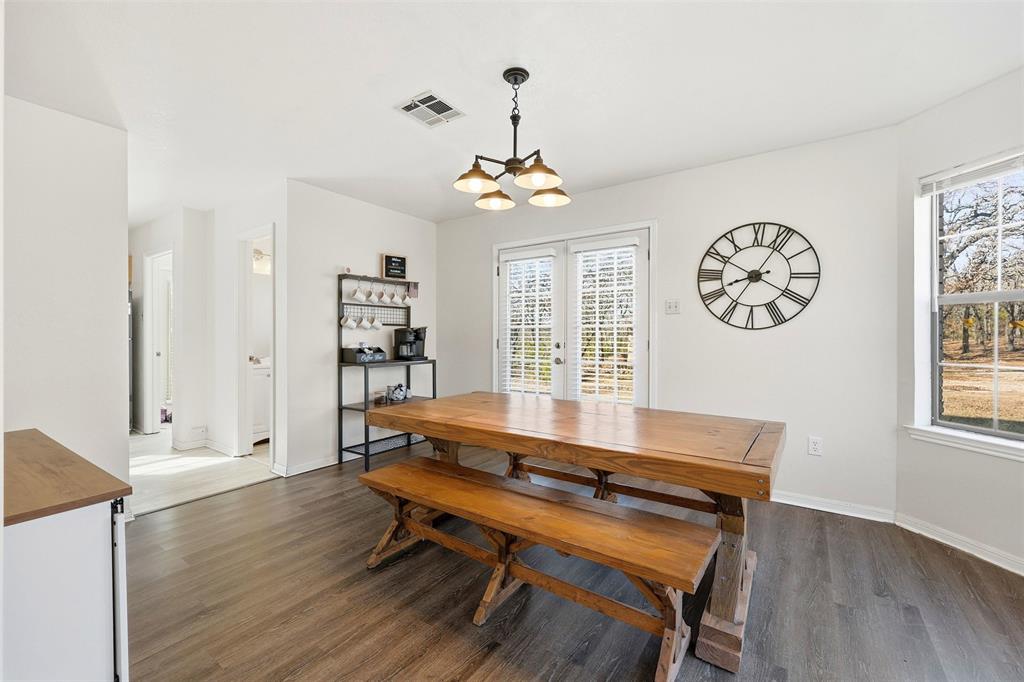 892 Hcr 1227 Whitney, TX 76692 - Photo 11 of 40 a dining room with wooden floor and a window