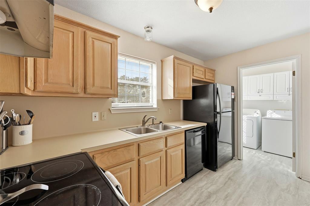 892 Hcr 1227 Whitney, TX 76692 - Photo 15 of 40 a kitchen with stainless steel appliances granite countertop a sink stove and refrigerator