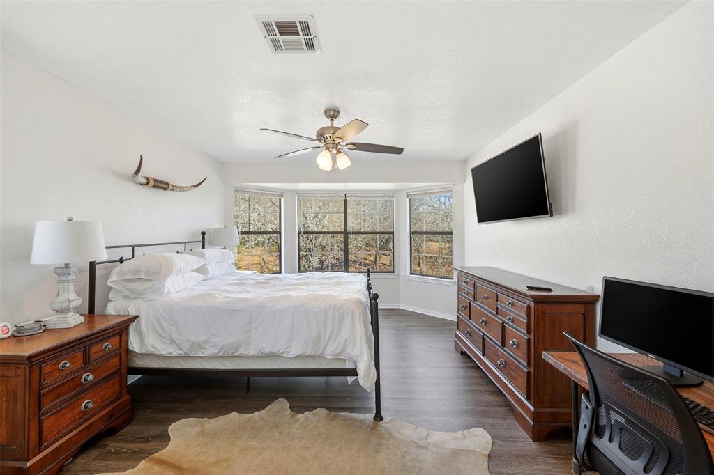 892 Hcr 1227 Whitney, TX 76692 - Photo 18 of 40 a bedroom with a bed and a flat screen tv