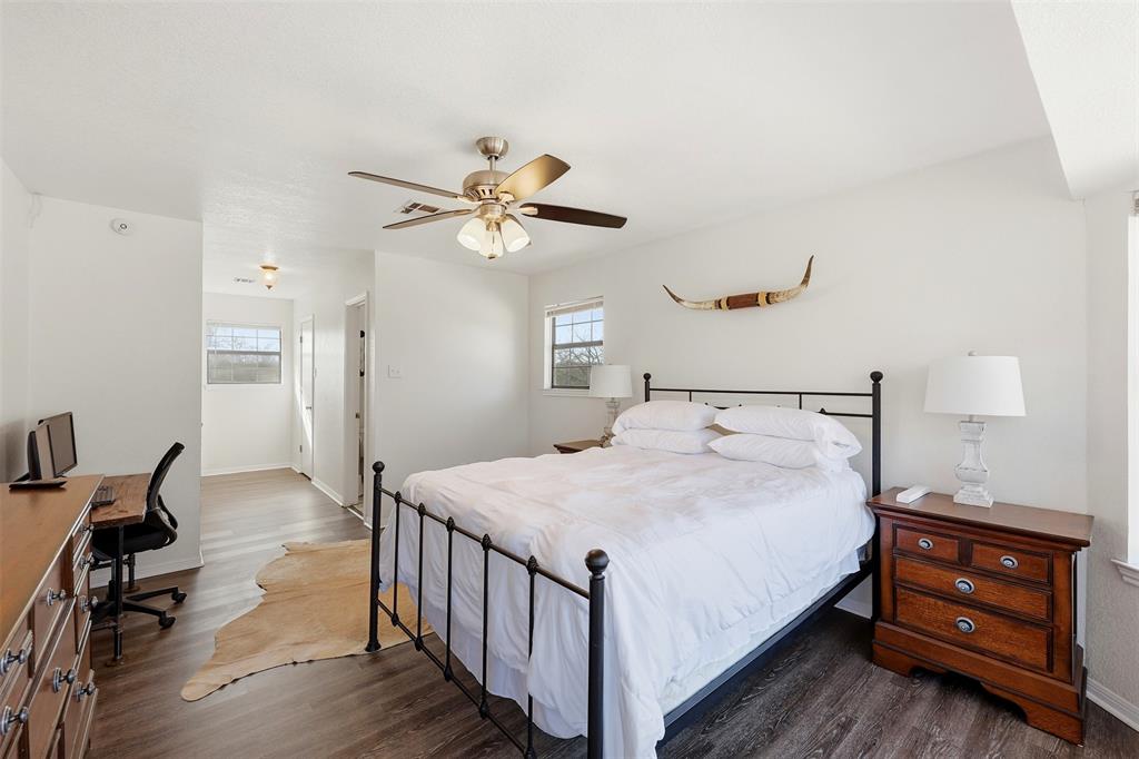 892 Hcr 1227 Whitney, TX 76692 - Photo 19 of 40 a bedroom with a bed and a chandelier