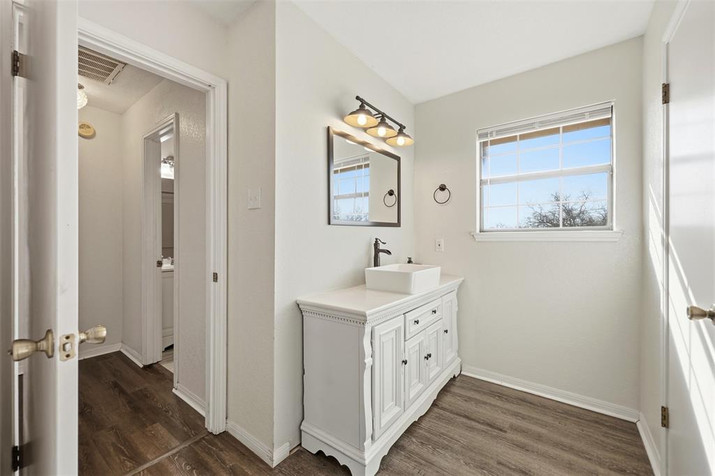 892 Hcr 1227 Whitney, TX 76692 - Photo 21 of 40 a spacious bathroom with a double vanity sink and a mirror