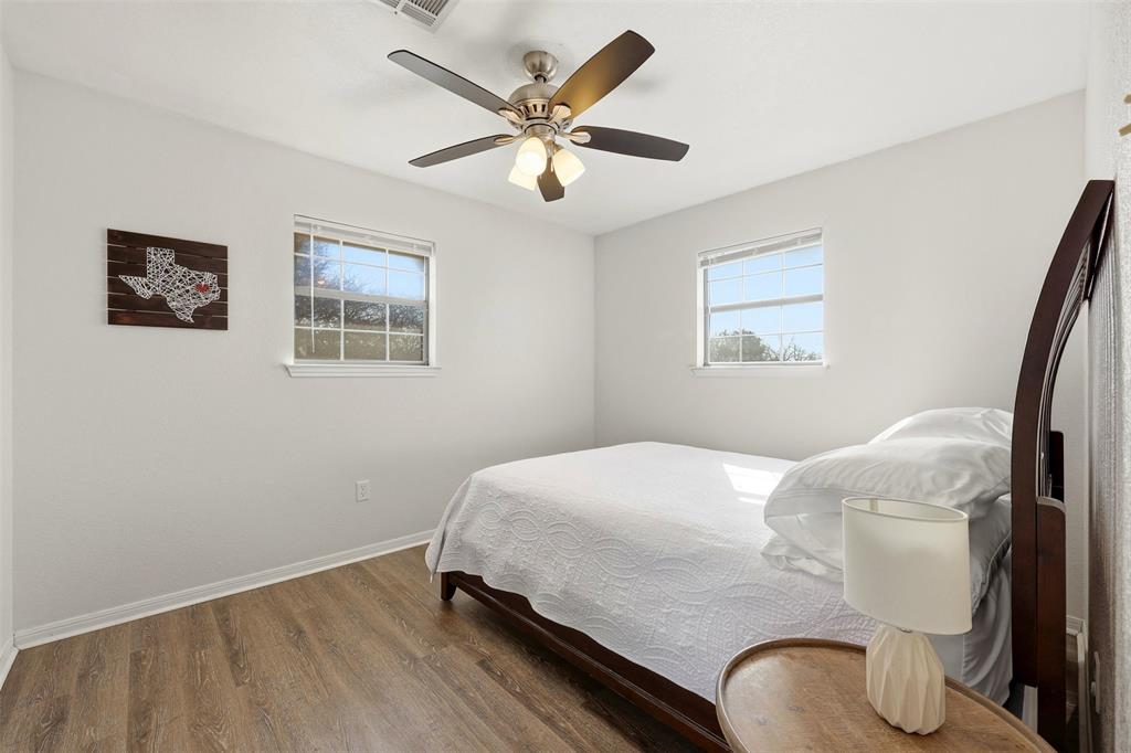 892 Hcr 1227 Whitney, TX 76692 - Photo 24 of 40 a bedroom with a bed and a chandelier