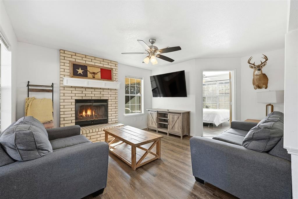892 Hcr 1227 Whitney, TX 76692 - Photo 7 of 40 a living room with furniture a fireplace and a flat screen tv