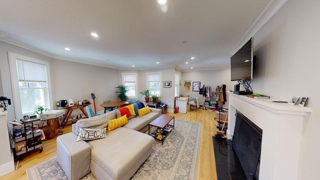15 Lanark Road, Unit 3 Brookline, MA 02445 - Photo 3 of 9 a living room with furniture and a flat screen tv