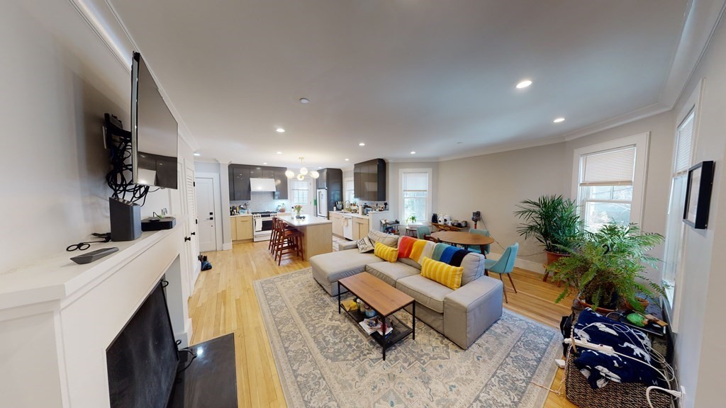 15 Lanark Road, Unit 3 Brookline, MA 02445 - Photo 4 of 9 a living room with furniture and a flat screen tv