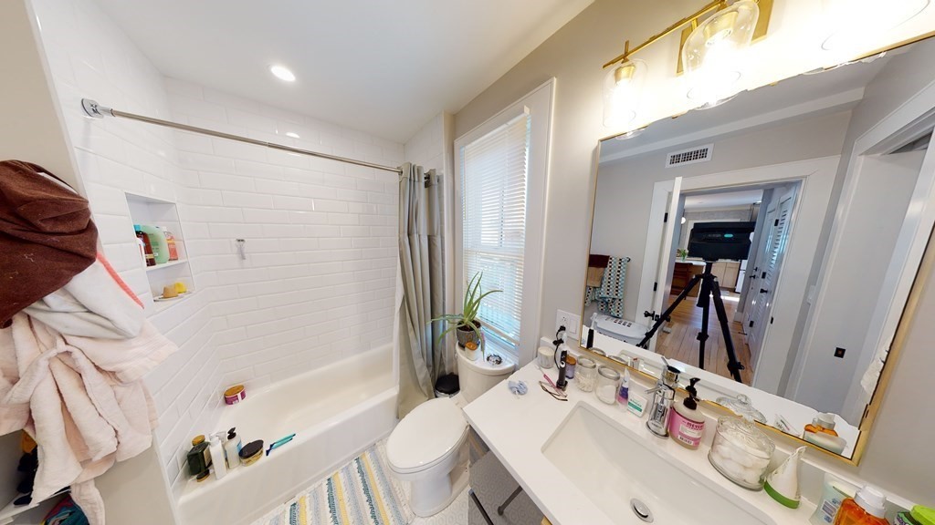 15 Lanark Road, Unit 3 Brookline, MA 02445 - Photo 6 of 9 a bathroom with a sink mirror and a bath tub