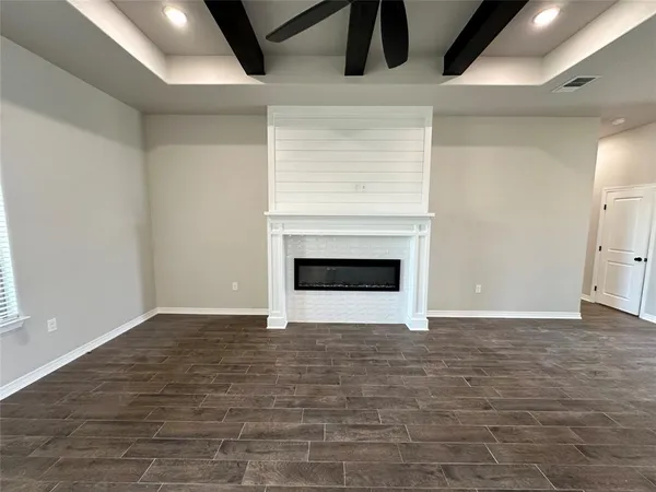 a view of an empty room with a fireplace