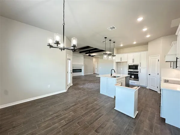 a living room with furniture and kitchen view