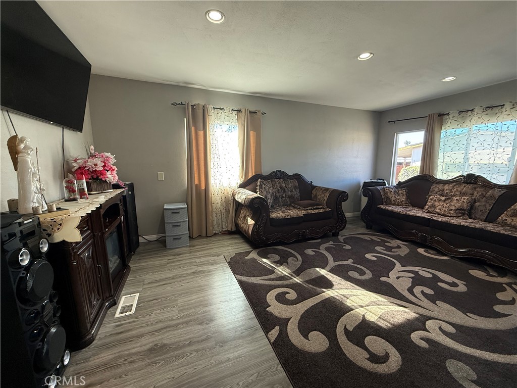 2601 East Victoria Street, Unit 404 Compton, CA 90220 - Photo 11 of 30 a living room with furniture and a flat screen tv