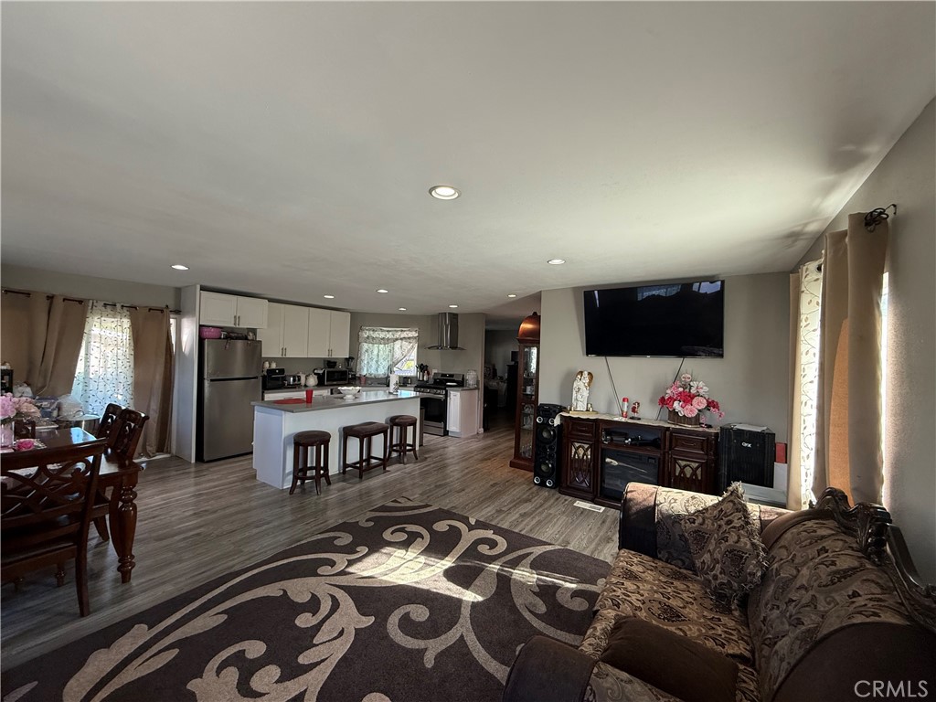 2601 East Victoria Street, Unit 404 Compton, CA 90220 - Photo 16 of 30 a living room with furniture and a flat screen tv