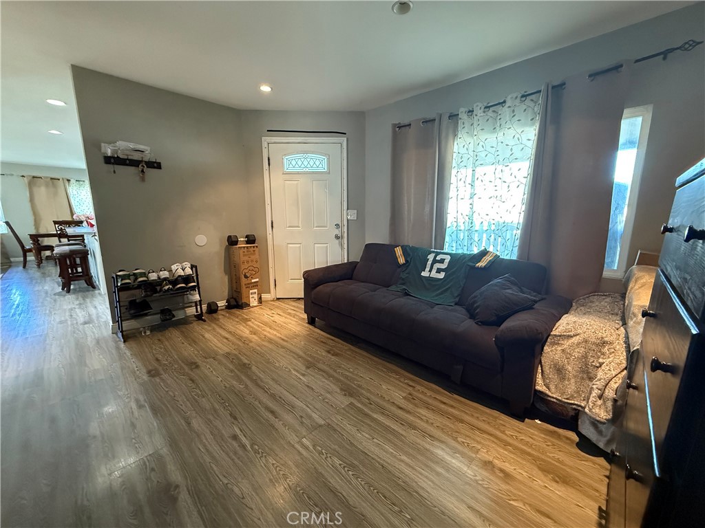 2601 East Victoria Street, Unit 404 Compton, CA 90220 - Photo 18 of 30 a living room with furniture and a wooden floor