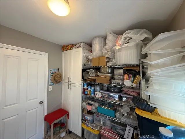 a bedroom with a bed and flat tv screen on the dresser