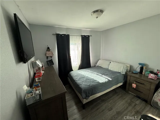 a bedroom with a bed and a chair