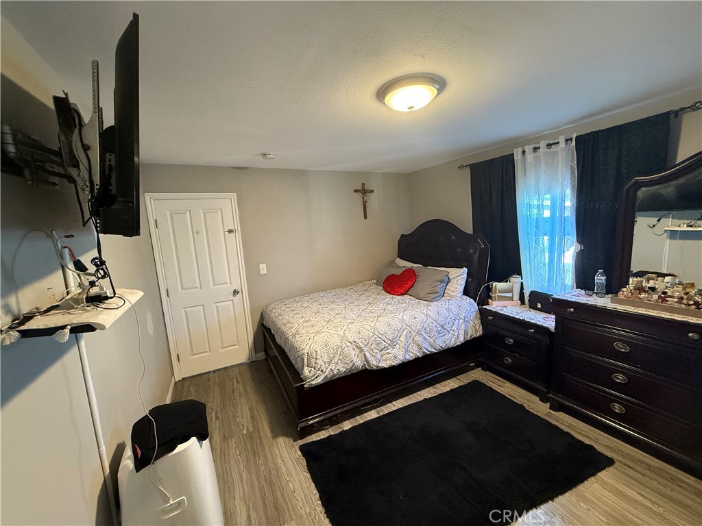 2601 East Victoria Street, Unit 404 Compton, CA 90220 - Photo 27 of 30 a bedroom with a bed and flat tv screen on the dresser