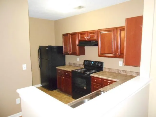 a kitchen with a sink and a stove