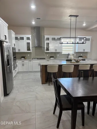 a large kitchen with a table and chairs