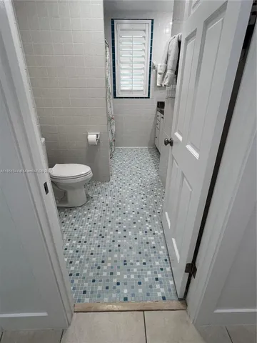 a bathroom with a sink a toilet and a shower