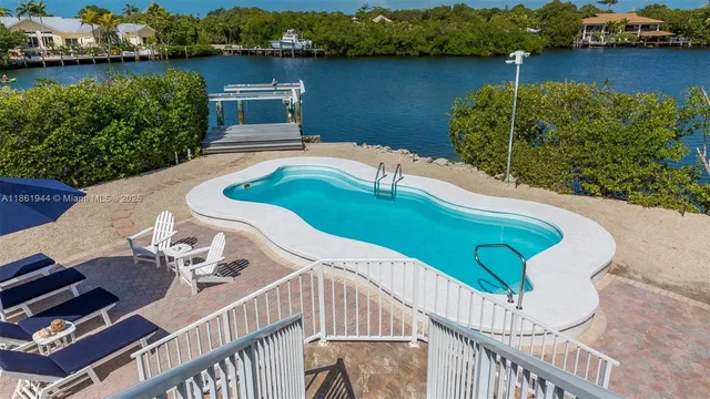 an aerial view of a house having roof deck and lake view