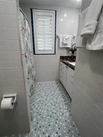a bathroom with a toilet and a shower curtain