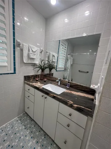 a kitchen with stainless steel appliances a sink a stove a refrigerator and cabinets