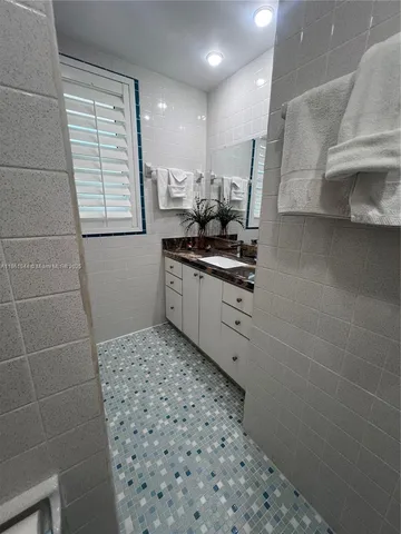 a bedroom with two beds and a window