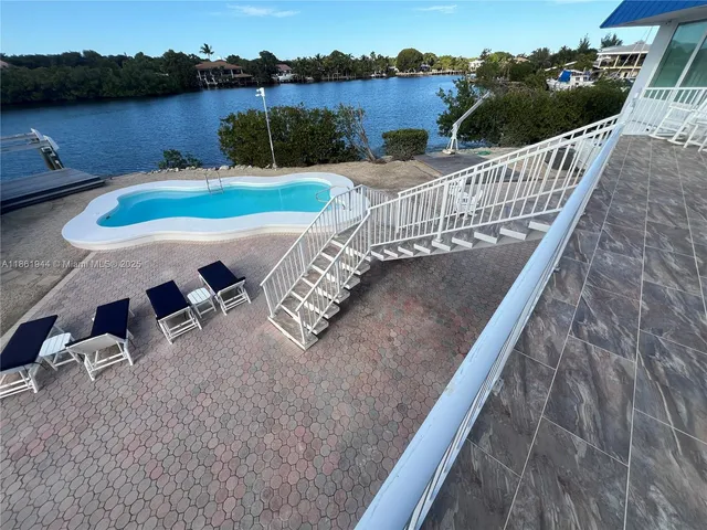 a view of a swimming pool with a lounge chairs