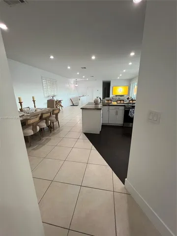 a kitchen with a sink a refrigerator and cabinets