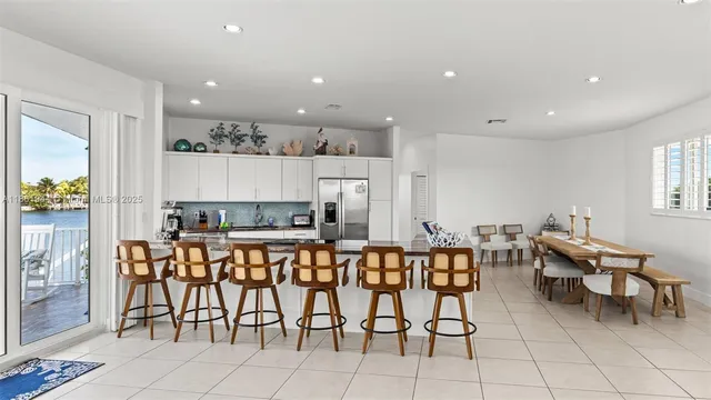 a large kitchen with a table and chairs in it