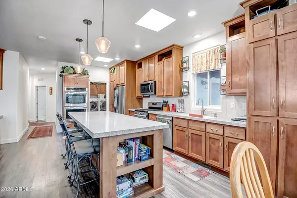 a large kitchen with lots of counter space and refrigerator