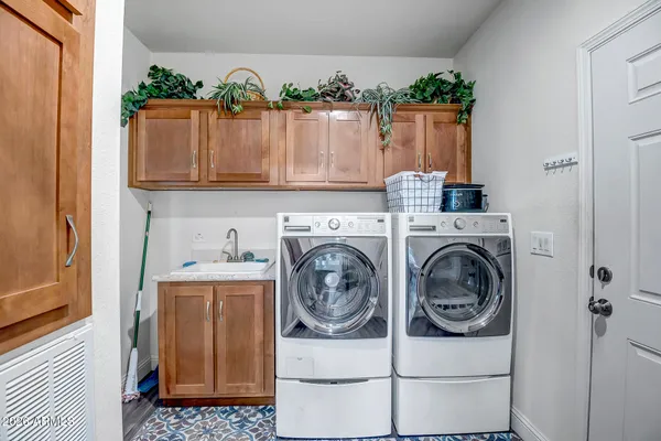 a utility room with sink dryer and washer
