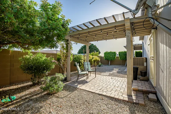 a view of a patio with table and chairs potted plants