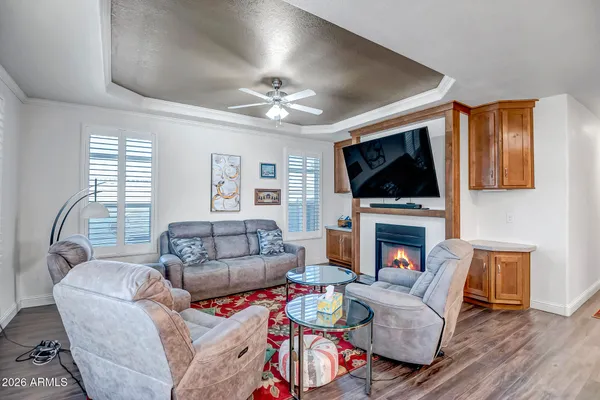 a living room with furniture a flat screen tv and a fireplace