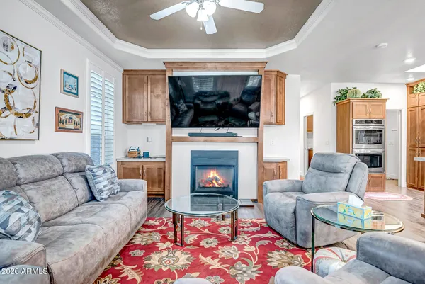 a living room with furniture a flat screen tv and a fireplace