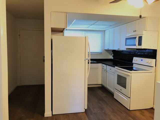 a kitchen with a refrigerator and a stove