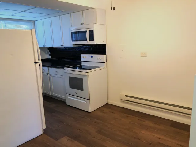 a kitchen with a stove microwave and sink