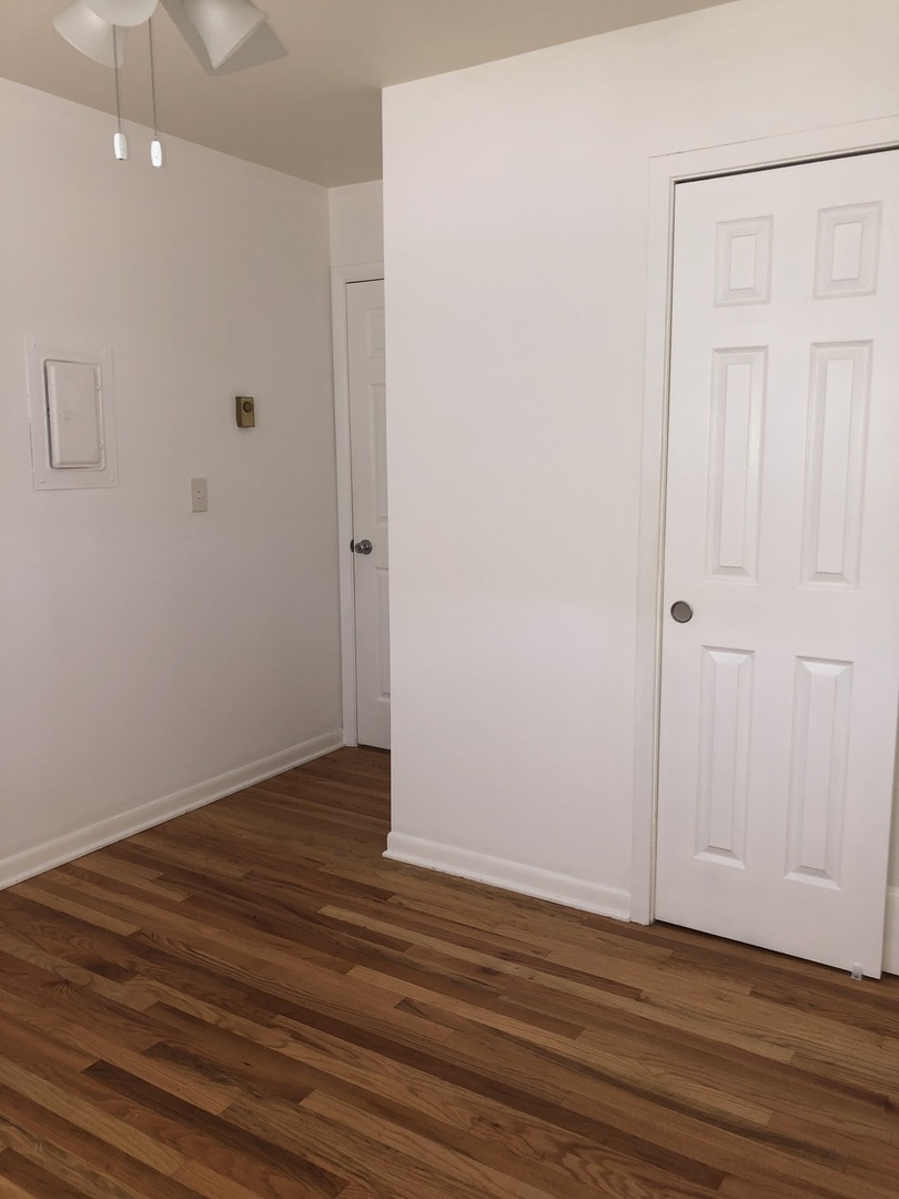 85 North Lyle Avenue, Unit 5 Elgin, IL 60123 - Photo 6 of 11 a view of an empty room with wooden floor