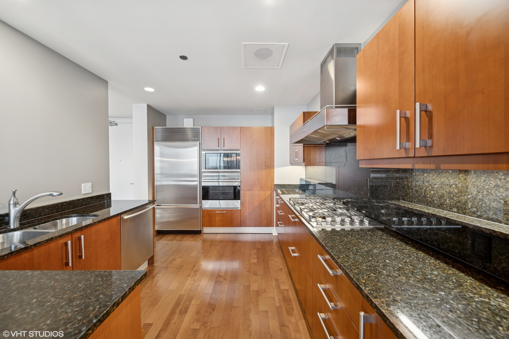 401 North Wabash Avenue, Unit 49I Chicago, IL 60611 - Photo 9 of 16 a kitchen with stainless steel appliances granite countertop a lot of counter space and wooden floors