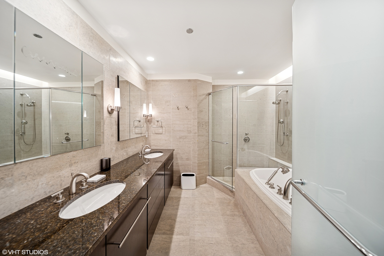 401 North Wabash Avenue, Unit 49I Chicago, IL 60611 - Photo 10 of 16 a bathroom with a granite countertop sink a mirror a bathtub and shower