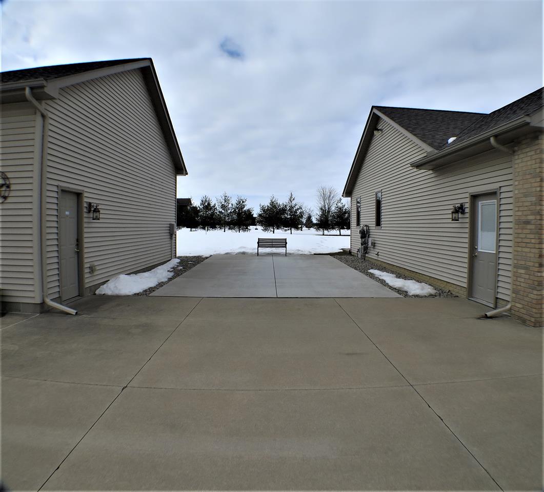 1420 South Morrish Road Flint, MI 48532 - Photo 22 of 32 Concrete between house and pole barn is a perfect place to park a camper or set up tables for a family/friends gathering.