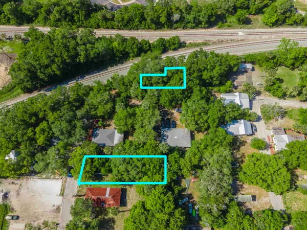 an aerial view of a house with a yard and outdoor seating