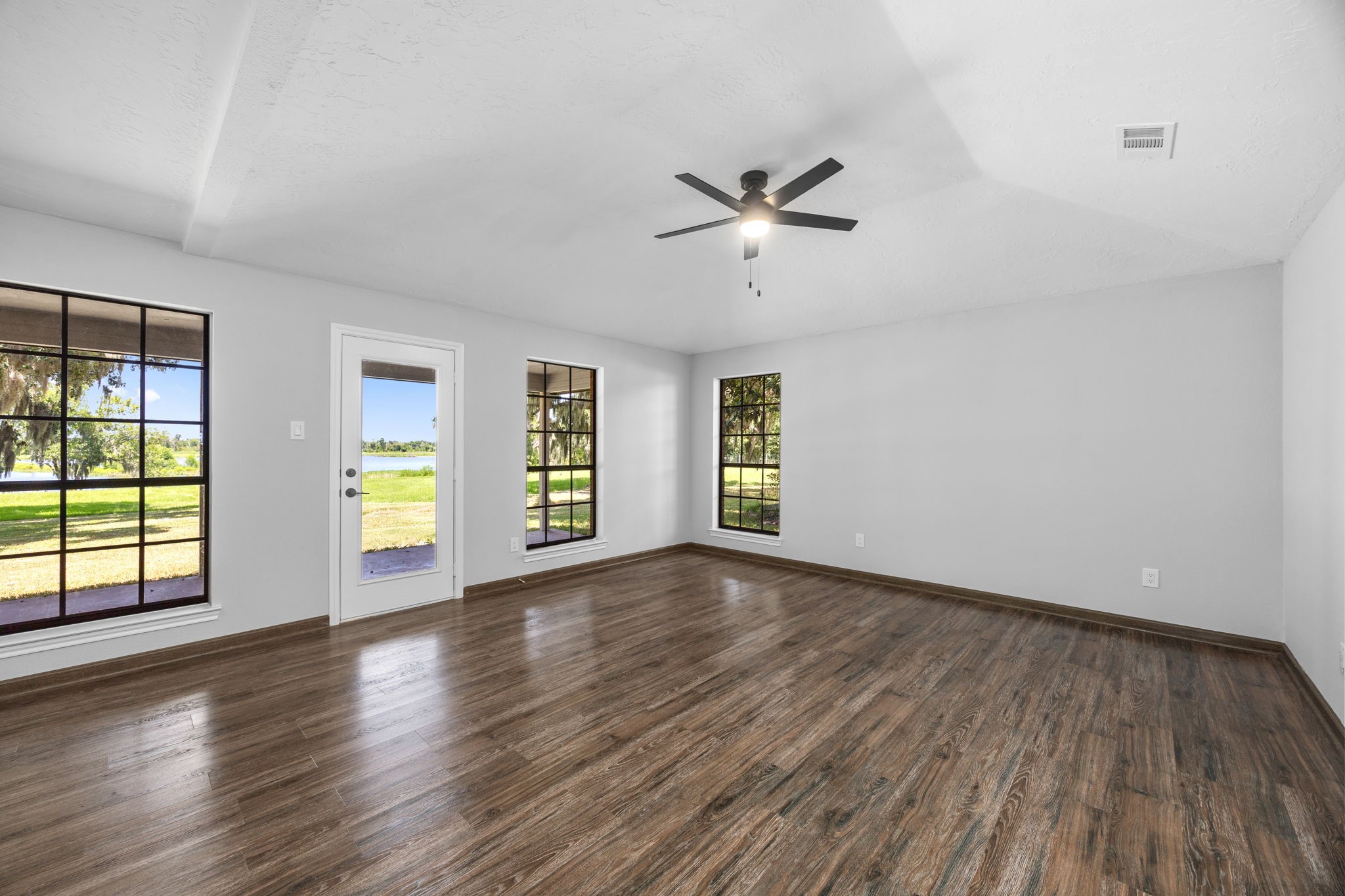 21802 Lake View Road Damon, TX 77430 - Photo 33 of 49 Wake up to beautiful water views and direct access to the covered patio from your private primary suite.